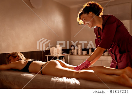 Anti cellulite massage for young woman in beauty salon. Perfect skin fat burning beauty concept Anti cellulite massage for young woman in beauty salon. Perfect skin fat burning beauty concept 95317232