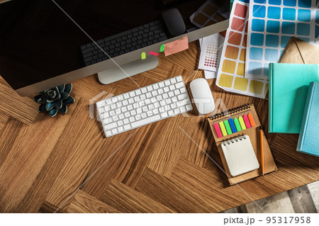 Designer's workplace with modern computer and color palettes, flat lay. Space for text Designer's workplace with modern computer and color palettes, flat lay. Space for text 95317958