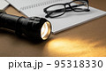Office supplies with glowing flashlight on a brown recycled craft paper background 95318330