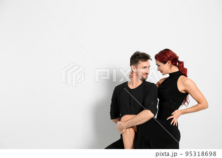 Beautiful young couple dancing in studio, space for text Beautiful young couple dancing in studio, space for text 95318698