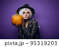 Scared surprised witch with grey hair on Halloween 95319203
