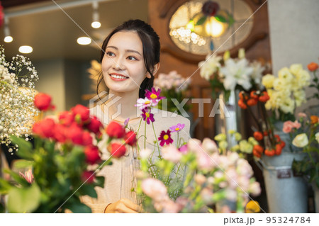 花屋で花を選ぶ女性 95324784