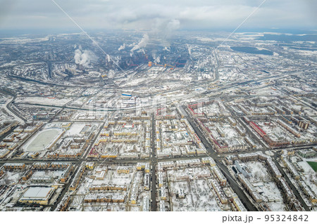 Winter view of the center of the city of Nizhny Tagil and the metallurgical plant from above. Environmental problem of environmental pollution and air in large cities 95324842