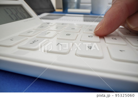 Close-up view of using calculator, shot with macro probe lens Close-up view of using calculator, shot with macro probe lens 95325060