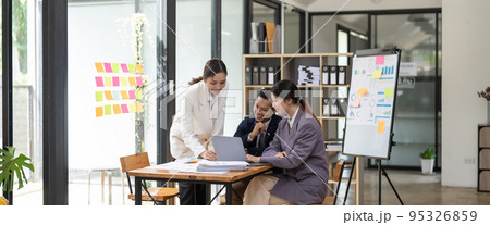 Group of young business people working and communicating while sitting at the office desk together with colleagues. Project and Business concept. 95326859