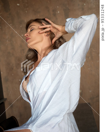 Beautiful adult woman stretches herself 95331248