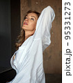 Beautiful adult woman stretches herself 95331273