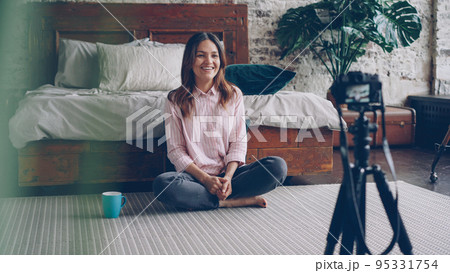 Attractive asian woman famous blogger is recording video for her online vlog using camera, she is talking and gesturing and smiling. 95331754