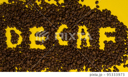 Inscription on decaffeinated coffee beans, top view of coffee. Inscription on decaffeinated coffee beans, top view of coffee. 95333973