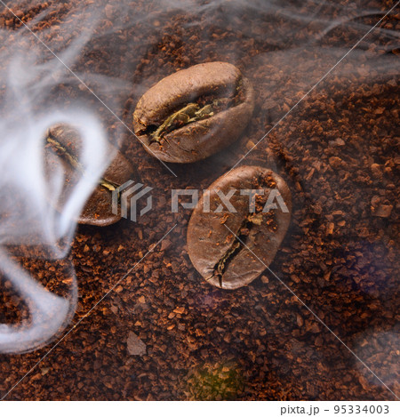Ground coffee and coffee beans, coffee in light smoke. 95334003