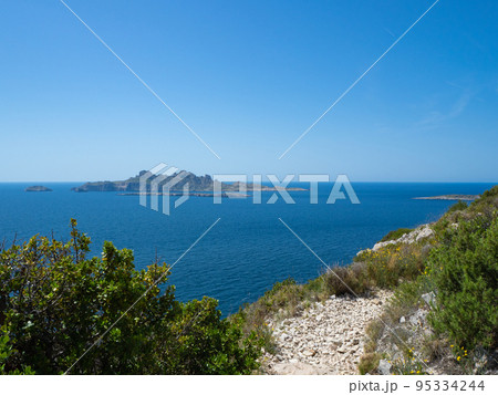 Calanques, France - May 20th 2020: Hiking high above the Mediterranean Sea along a rocky coast Calanques, France - May 20th 2020: Hiking high above the Mediterranean Sea along a rocky coast 95334244