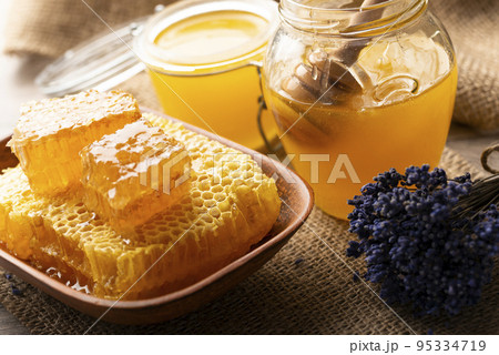 Honeycomb in clay dish on kitchen table sweet background Honeycomb in clay dish on kitchen table sweet background 95334719