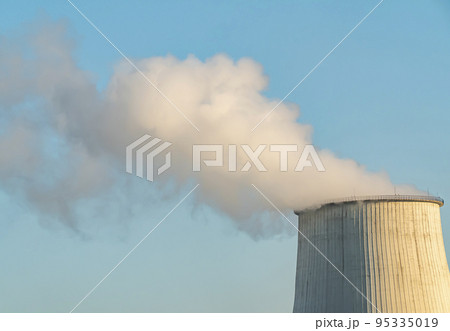 Smokestack of a thermal power plant against a blue sky. 95335019