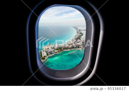 Cancun beach view from jet plane window 95336017