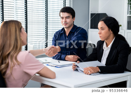 Young female asian candidate tries to impress interviewer by being competent. Young female asian candidate tries to impress interviewer by being competent. 95336646