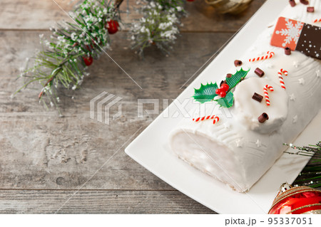 White chocolate yule log cake with christmas ornament isolated on white background White chocolate yule log cake with christmas ornament isolated on white background 95337051