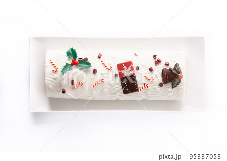 White chocolate yule log cake with christmas ornament isolated on white background 95337053