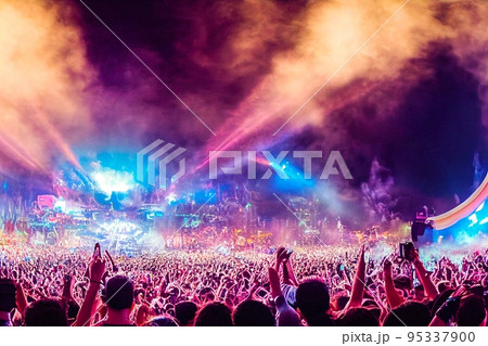 Crowd of people in music festival at spectacular night concert 95337900