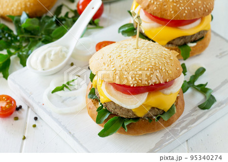 Arabic cuisine. Ramadan food. Homemade vegetarian mung cutlets burger on white a wooden kitchen table. Street food, fast food. Arabic cuisine. Ramadan food. Homemade vegetarian mung cutlets burger on white a wooden kitchen table. Street food, fast food. 95340274