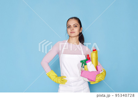 woman in gloves holding bucket with cleaning supplies 95340728