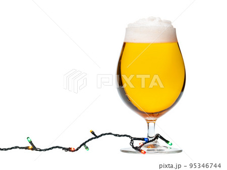 Tulip glass of beer with christmas lights isolated 95346744