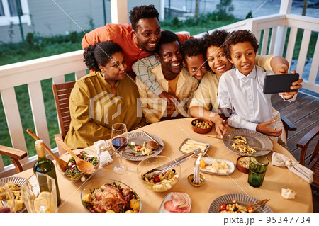 African American Family Taking Selfie Photo at Dinner 95347734