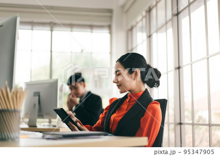 Adult business woman use tablet  to check notification stock market. 95347905