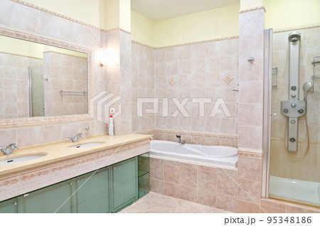 Clean bathroom in a hotel room with bath and shower. Clean bathroom in a hotel room with bath and shower. 95348186