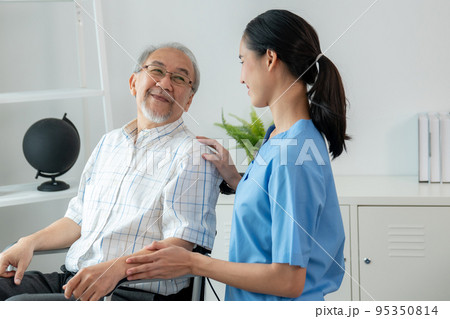 Happy positive asian nurse giving support and touching contented senior man. Happy positive asian nurse giving support and touching contented senior man. 95350814