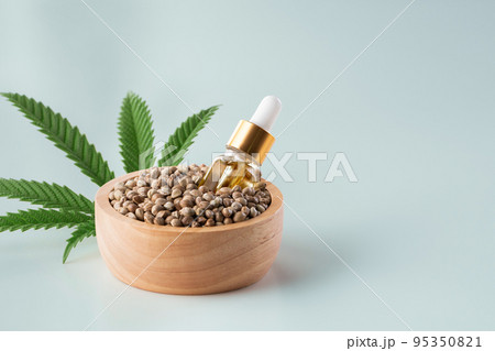 Hemp seeds with green sativa hemp leaf on top. Legalized marijuana concept. 95350821