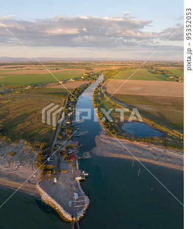 Nice aerial view of typical fishing huts at sunset near Ravenna 95352053