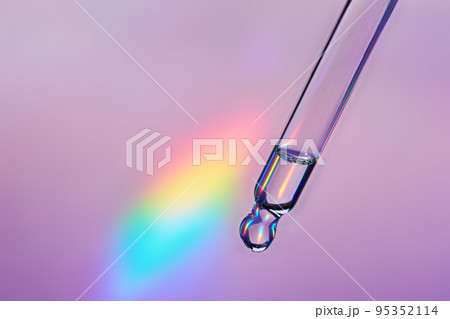 Pipette with cosmetic product on holographic background, iridescent highlights, selective focus Pipette with cosmetic product on holographic background, iridescent highlights, selective focus 95352114