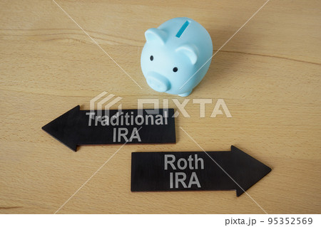 Blue piggy bank and arrows Traditional and Roth IRA. 95352569