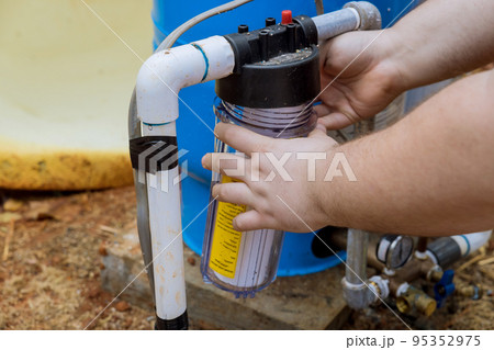 Water filter replacement is done by professionals in order to ensure that water stays clean outside home Water filter replacement is done by professionals in order to ensure that water stays clean outside home 95352975