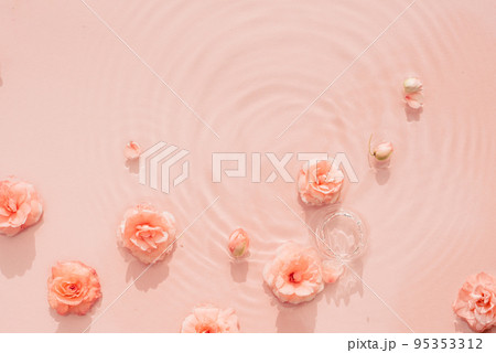 Pink aquatic, transparent water texture with ripples and drops and pink flowers. Water background Pink aquatic, transparent water texture with ripples and drops and pink flowers. Water background 95353312