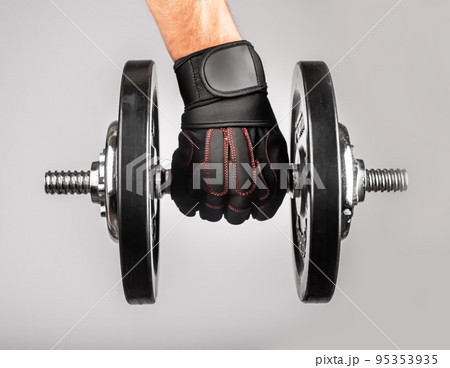 Hand holding heavy dumbbell 95353935