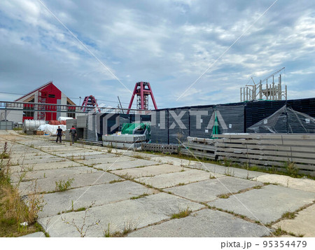 Boxes with equipment at the construction site of a factory in an open-air storage warehouse for storing materials and industrial equipment Boxes with equipment at the construction site of a factory in an open-air storage warehouse for storing materials and industrial equipment 95354479