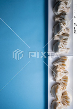 traditional georgian khinkali dumplings flatlay with copyspace, blue background 95355000
