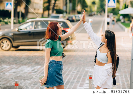 Two students high five to teach others after successful work together 95355768