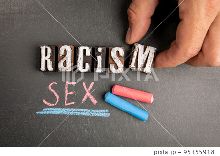 Racism and Sexism. Text and pieces of chalk on a blackboard Racism and Sexism. Text and pieces of chalk on a blackboard 95355918