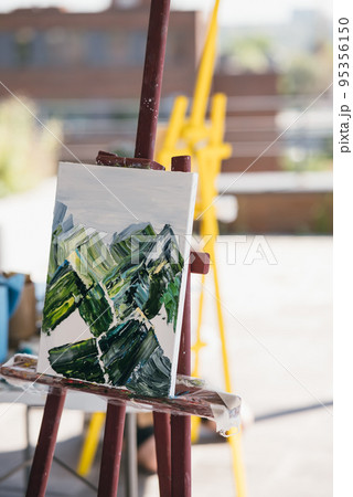 The unfinished painting on a wooden easel. The unfinished painting on a wooden easel. 95356150