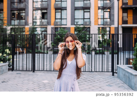 Woman on the background of large building Woman on the background of large building 95356392