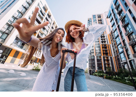 Two women are looking at the camera 95356400