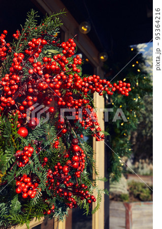 New Year and Christmas decorative wreath on the door. Vertical photo. New Year and Christmas decorative wreath on the door. Vertical photo. 95364216