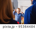 Adorable baby boy waiting gift from parents 95364484