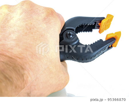 Construction tool black plastic clothespin on a white background. Construction tool black plastic clothespin on a white background. 95366870