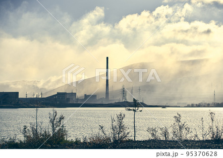 Industrial landscape with heavy pollution produced by a large factory. 95370628