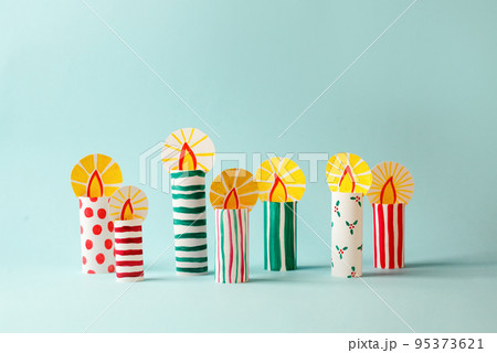 The child DIY for Jewish holiday of Hanukkah. Traditional candlestick 7 candles from toilet tube, recycle concept. Children's Art Project, needlework, crafts for children. 95373621