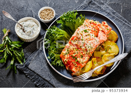 salmon with potato and tarragon sour cream sauce 95373934