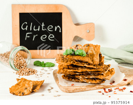 Gluten-free crispbreads on white wooden bg Gluten-free crispbreads on white wooden bg 95375914